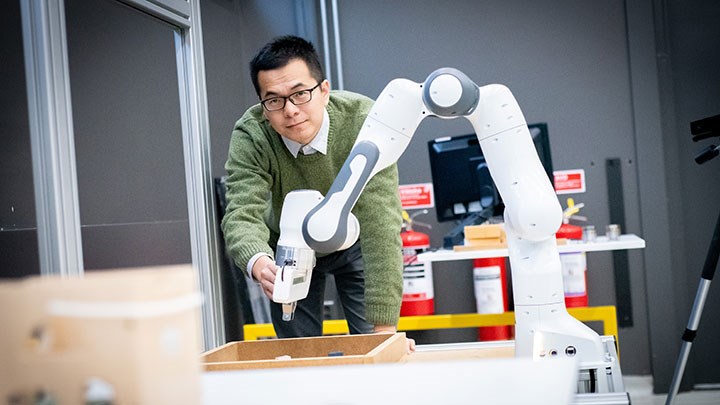Quantao Yang with a robot.