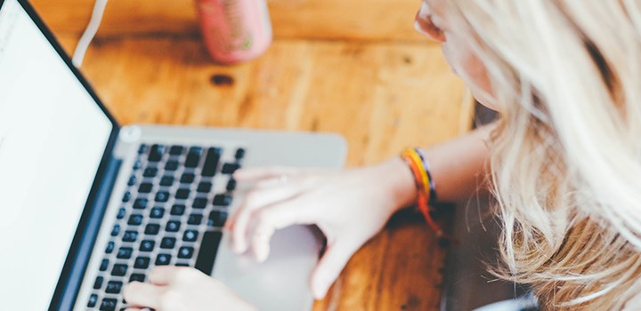 Photo of a person sitting with a laptop.