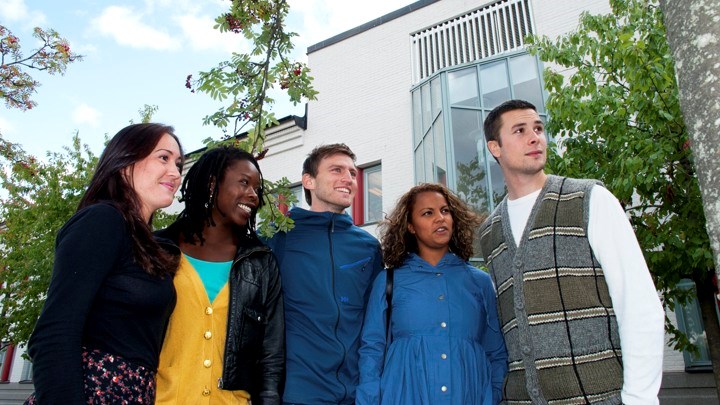 Students in a row smiling