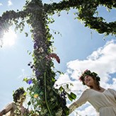 People dancing around a may pole