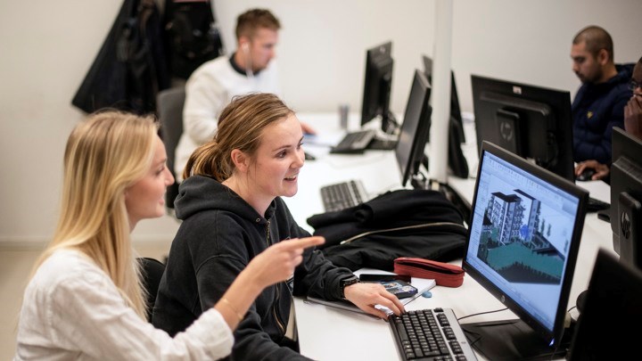 Students sitting by a computer