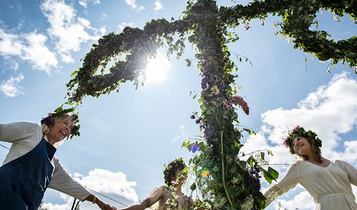 People dancing around the may pole