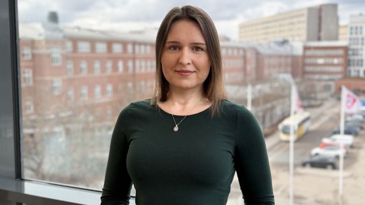 The researcher in front of a window.
