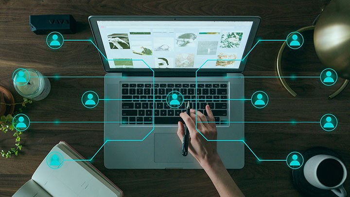 A laptop and graphic elements depicting a network