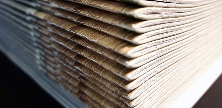 Close-up photo of a stack of journals.