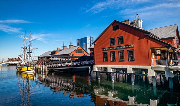 Ett museum som ligger vid vattnet. En segelbåt syns vid kajen.