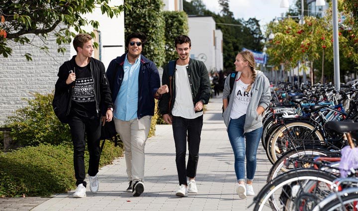 students walking by Långhuset