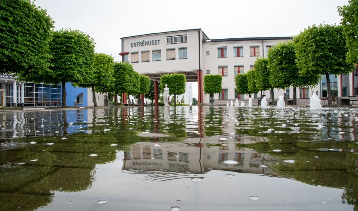 One of the university’s administrative buildings with a water feature in the foreground.