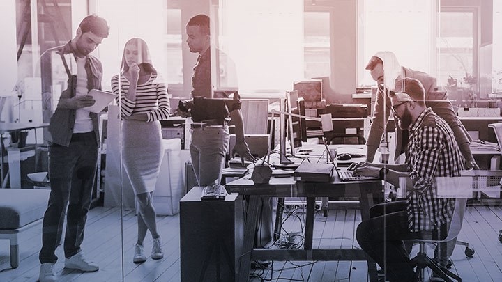 Group of people collaborating in a workshop or lab space.