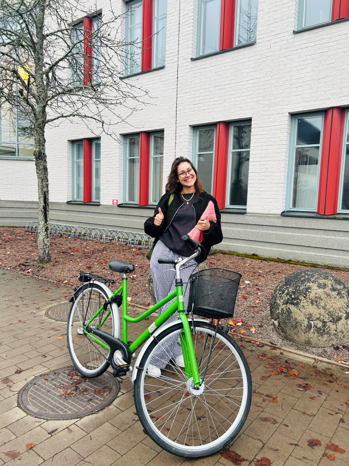 A girl with a bicycle.