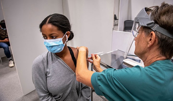 A young woman getting a COVID-19 vaccine.