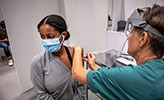 A young woman getting a COVID-19 vaccine.