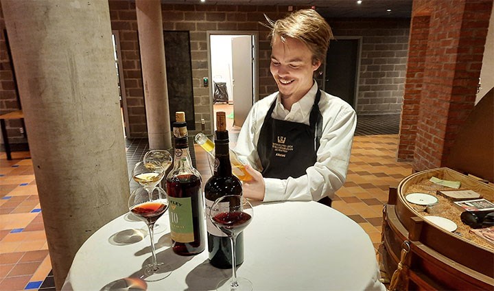 Karl Jonasson vid ett bord med vinglas och flaskor.