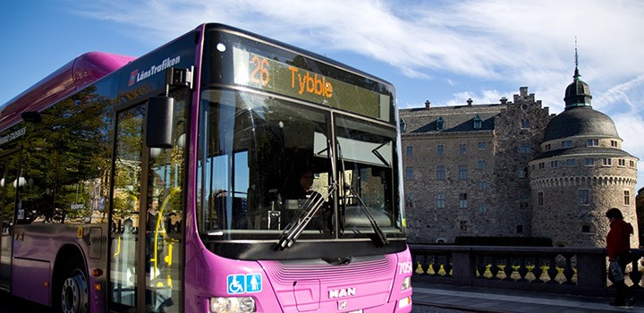 A bus and a castle in background.