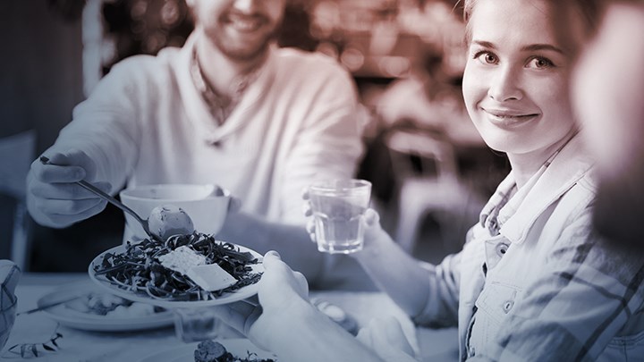 Two people eating food.