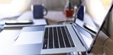 Photo of a laptop standing on a table.