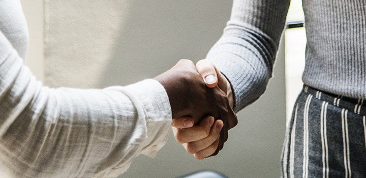 Photo of two people shaking hands.