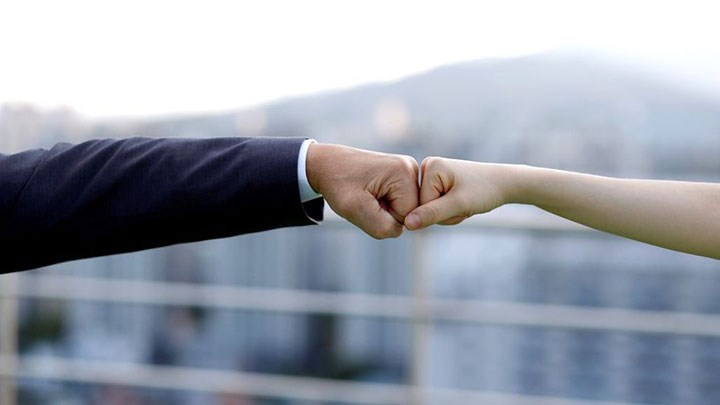 Two hands meeting in a fistbump.