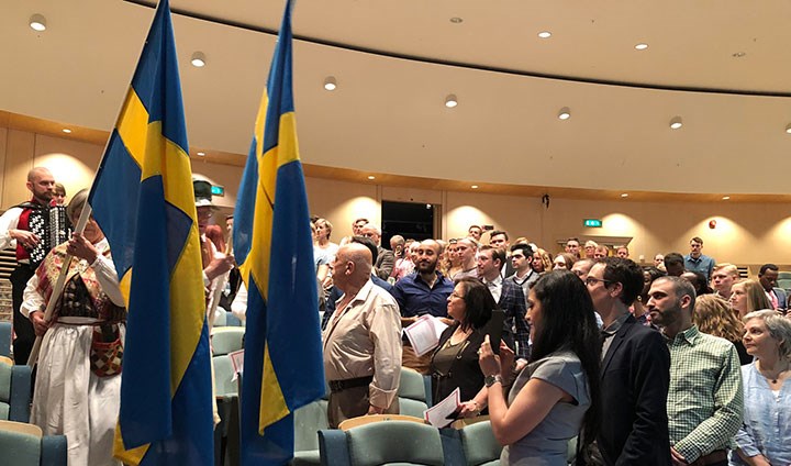 The graduation ceremony opened with folk music and a flag parade in the University Library’s assembly hall.