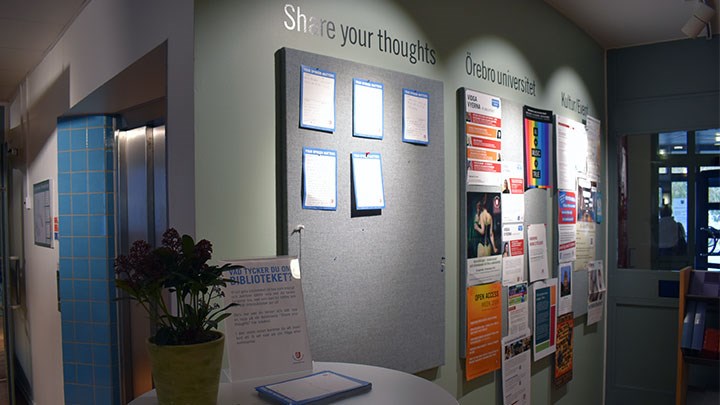 Photo of a bulletin board and a small table.
