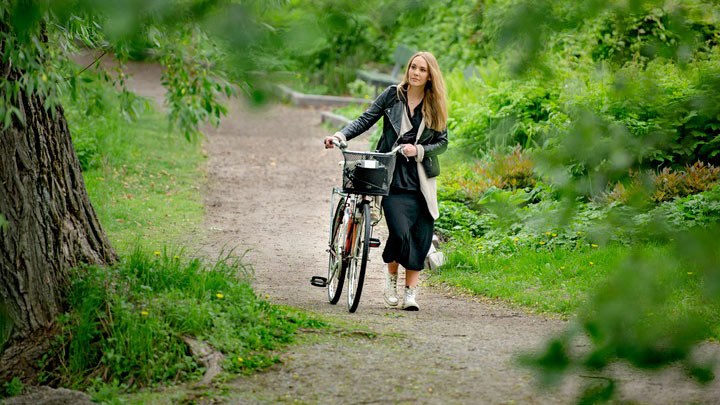 A woman with a bicycle.