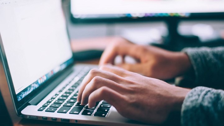 A person typing on a computer