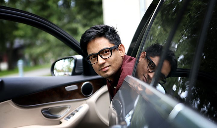 Ravi Chadalavada sitting in a car wearing eye-tracking glasses.