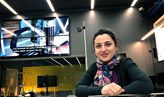 Marjan Alirezaie sitting at a desk in front of a large multi-screen