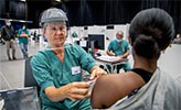 A young woman getting a COVID-19 vaccine.