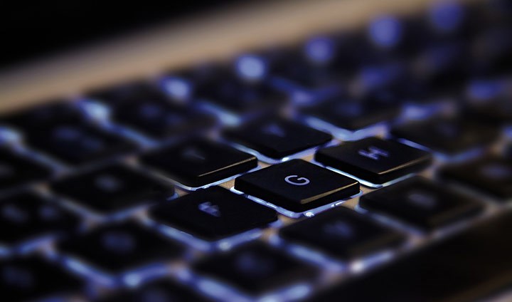 The G key is illuminated on a keyboard.