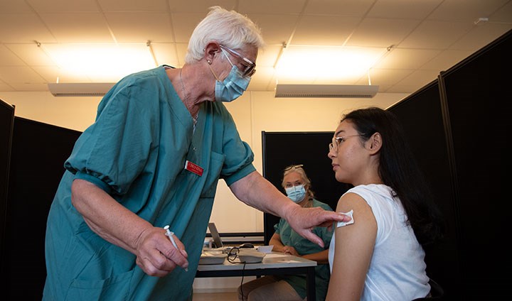 A young woman getting a COVID-19 vaccine.