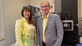 Two researchers in front of laboratory equipment