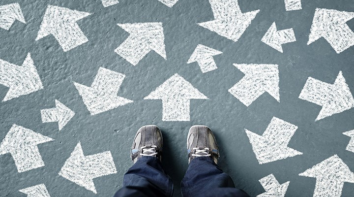 Taking decisions for the future. Woman standing with many directions arrow choices, left, right, or move forward.