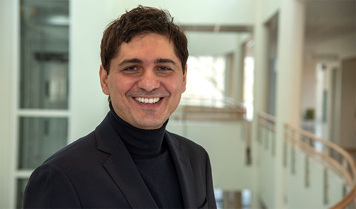 The picture shows researcher Petre Breazu holding his doctoral thesis.