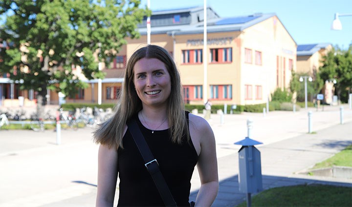 Moa Westh framför en byggnad på Örebro universitet.