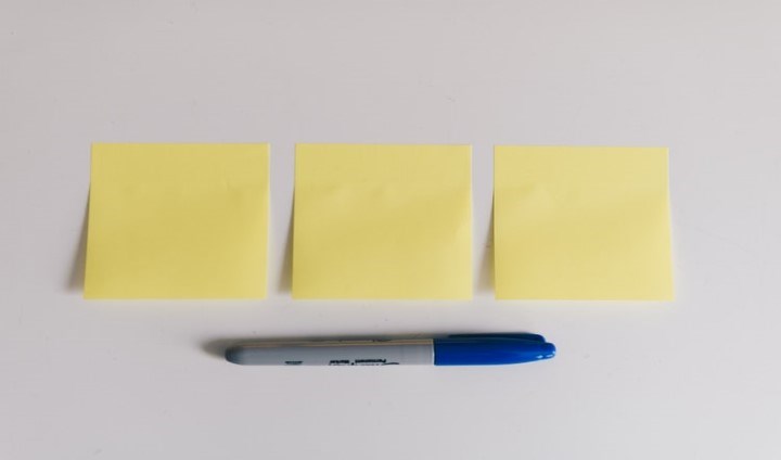 Tre gula post-it-lappar på rad med blå färgpenna under