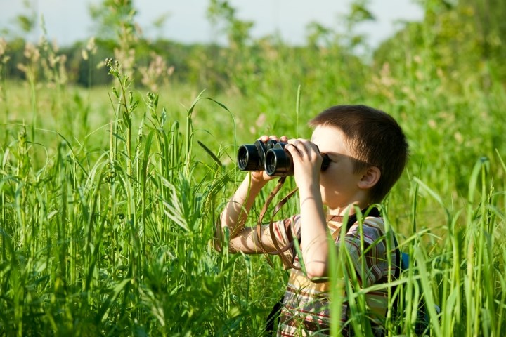 Child looking through binoculars