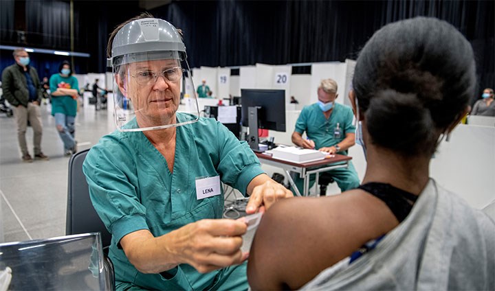 A woman gets vaccinated.