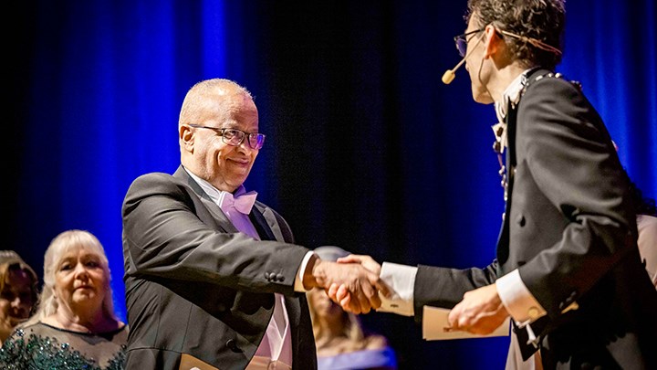 Mussie Msghina shaking hands vice-chancellor.
