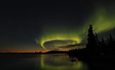 Northen light over a forest lake