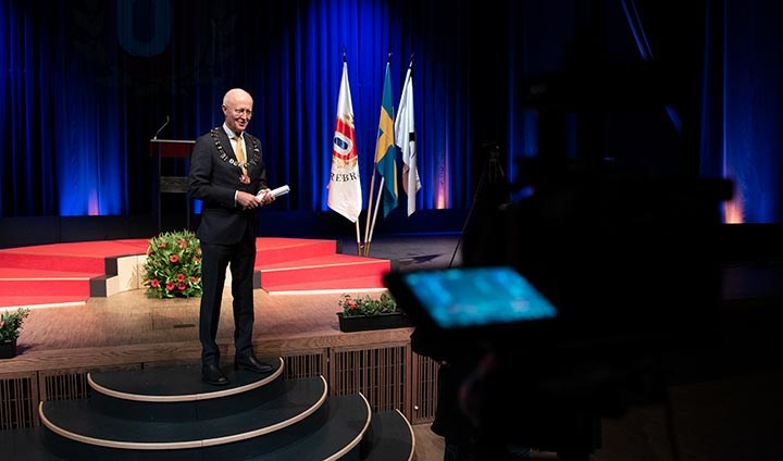 Rektor Johan Schnürer bli filmad på scenen.