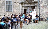 Exchange students queuing for a guided tour of Örebro Castle.