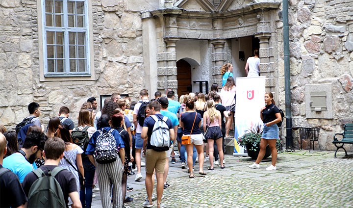 Exchange students queuing for a guided tour of Örebro Castle.