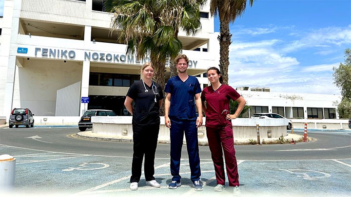 Three medical students outside a hospital in Cyprus.