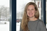 Tylor Kinde in front of a window. Snow outside.