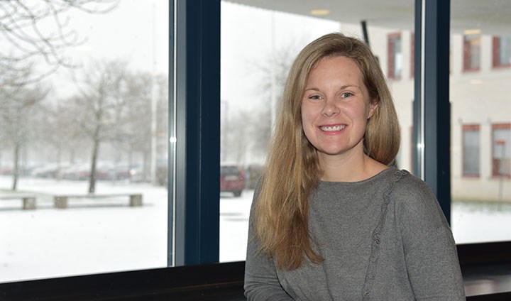 Tylor Kinde in front of a window. Snow outside. 