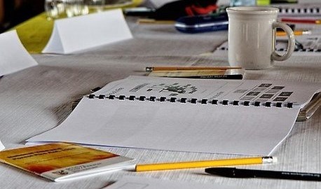 A notepad and pencil on a table.