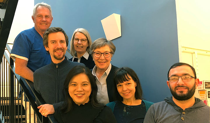 Researchers in a stair looking happy