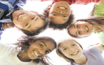 A group of young people looking into the camera. They are happy.