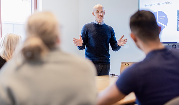 Researcher talking in front of class